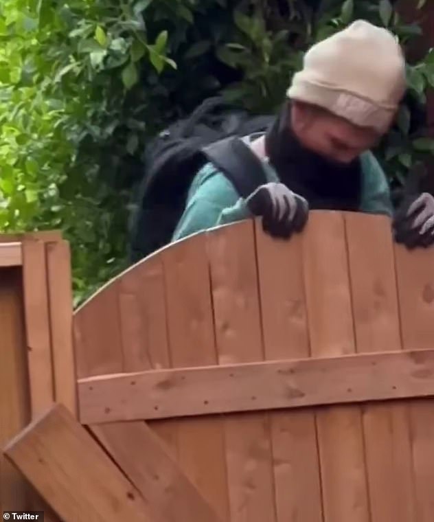 The alleged intruder's face can be seen as he climbed the fence to escape