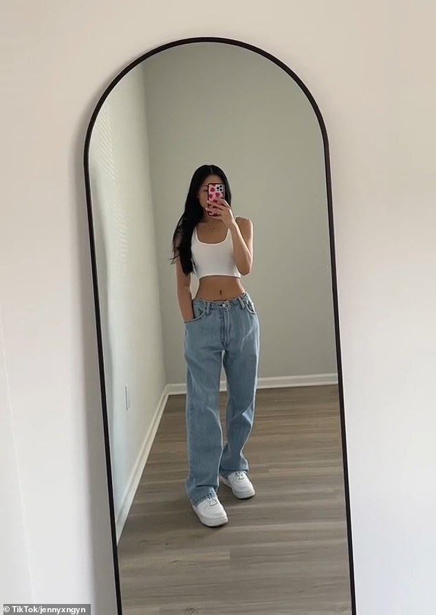 The TikToker tries on the custom jeans to show how they now fit her perfectly