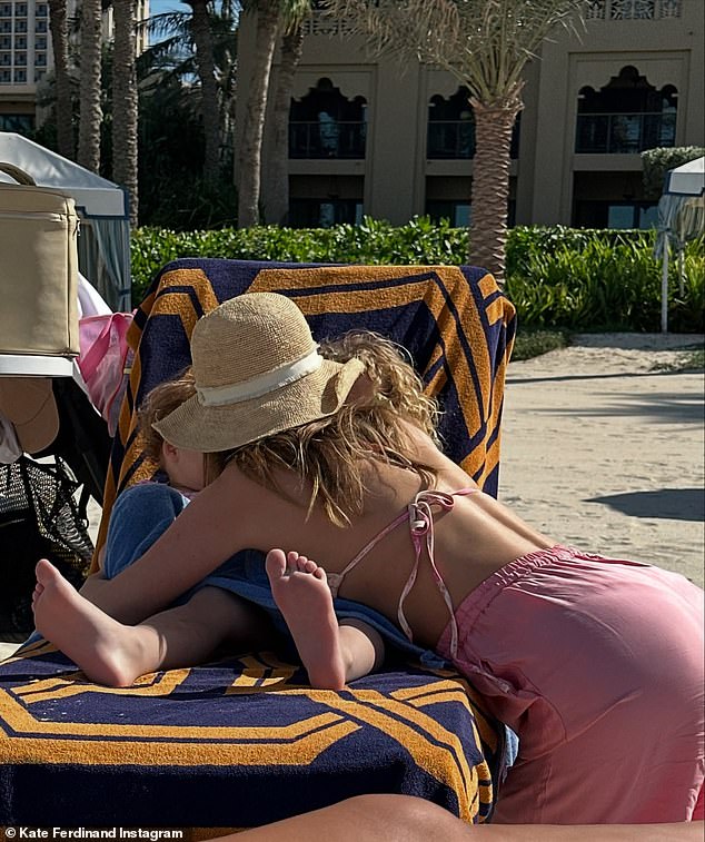 The WAG was seen hugging her two children, son Cree, four, and 18-month-old daughter Shae, as they relaxed on the same sun lounger on the beach