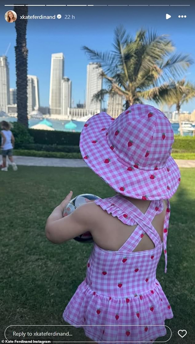 Shae also enjoyed a sun-filled day and looked adorable in a pink and white strawberry swimsuit and matching hat as she held a mini football.