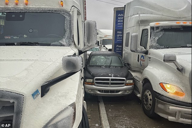 Salina, Kansas: A photo released by Kansas Highway Patrol shows a car stuck between two trucks due to icy weather on January 4