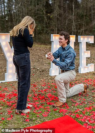 Jordan got down on one knee and wore a blue denim shirt, tan pants and brown western boots