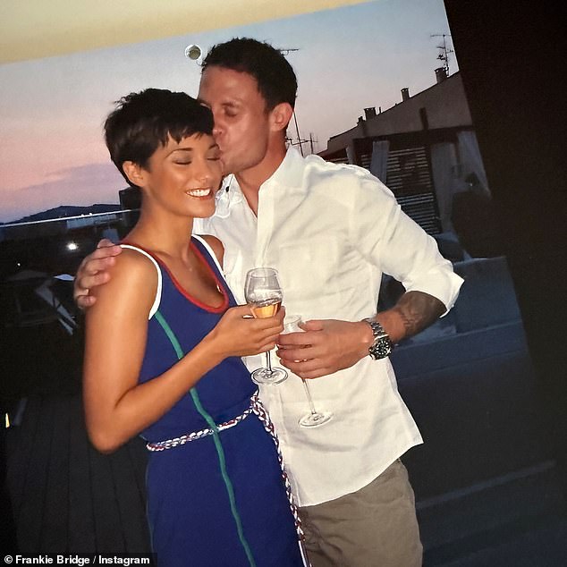 Frankie, 35, looked worlds away as she rocked a raven pixie haircut while the former footballer, 44, was captured stamping a passionate smooch on her cheek