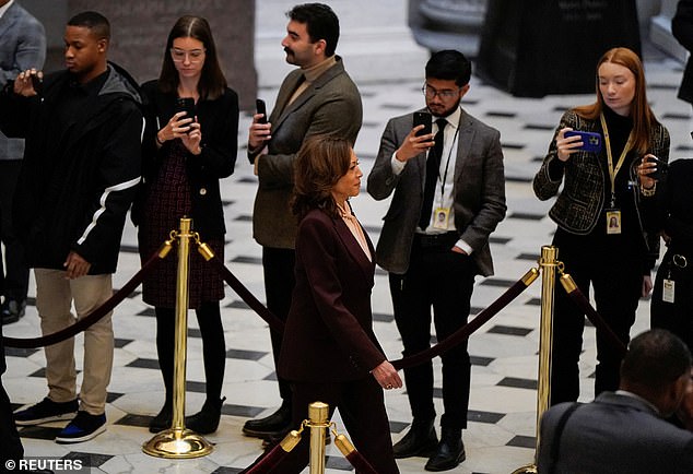 Reporters take photos of Vice President Kamala Harris as she walks to the House chamber on Monday to confirm the election of President-elect Donald Trump, her 2024 opponent