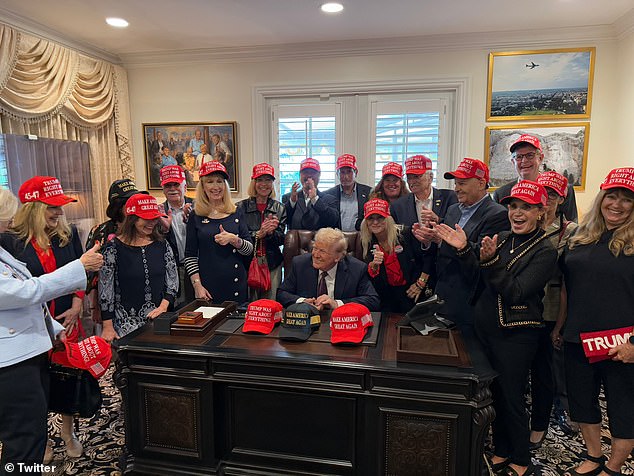 “The President meets his hardworking correspondence volunteers and signs hats,” the photo caption read