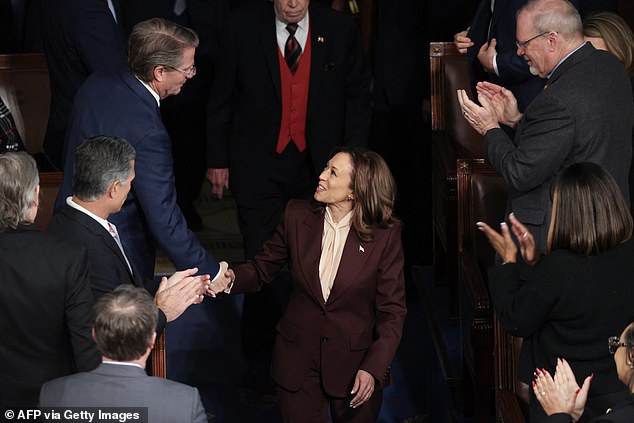 Harris shakes hands with Republican Tennessee Rep. Tim Burchett as he walks into the House chamber Monday afternoon