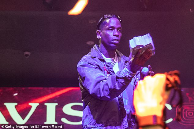 Scott carries a ton of cash as he performs at a Miami nightclub last month