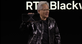 Nvidia CEO Jensen Huang holding the RTX 5090 at CES 2025