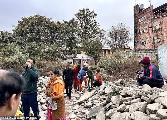 People gather in an open space after the earthquakes in Kathmandu, in the early hours of January 7, 2025