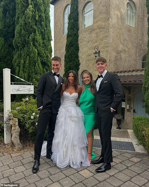 The happy couple beamed as they posed for photos with guests during the ceremony