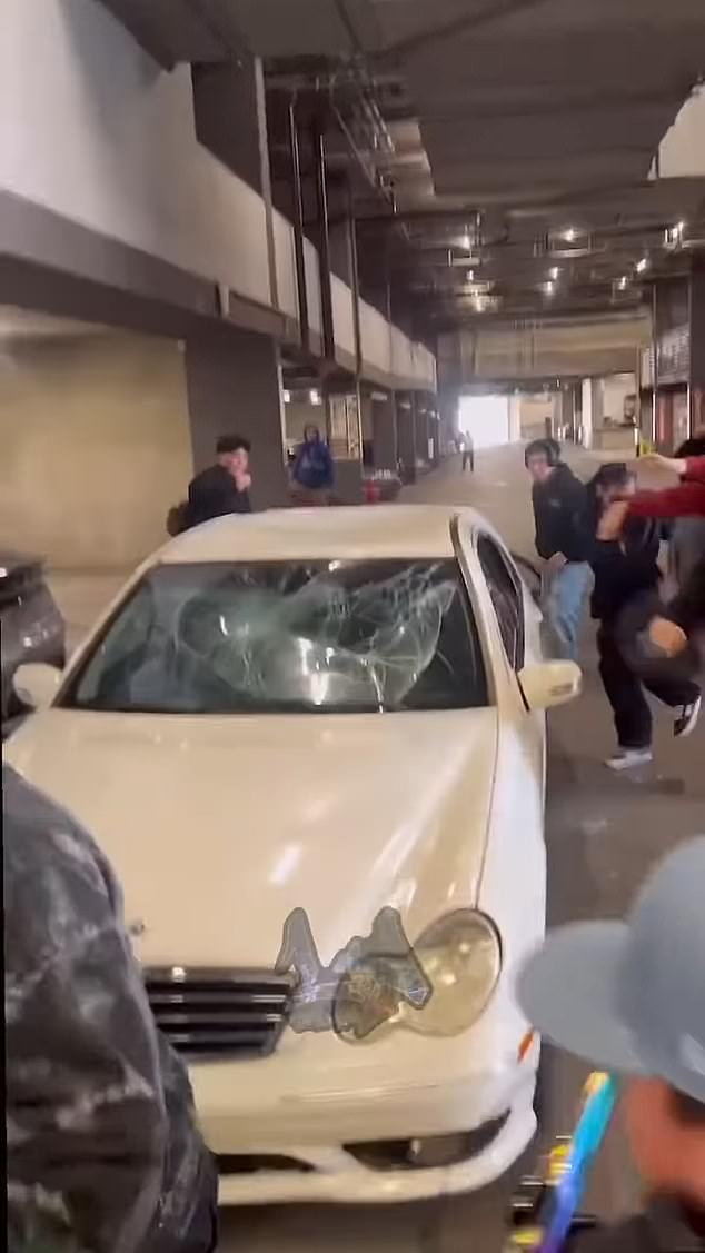 The white Mercedes-Benz was vandalized while parked in a garage