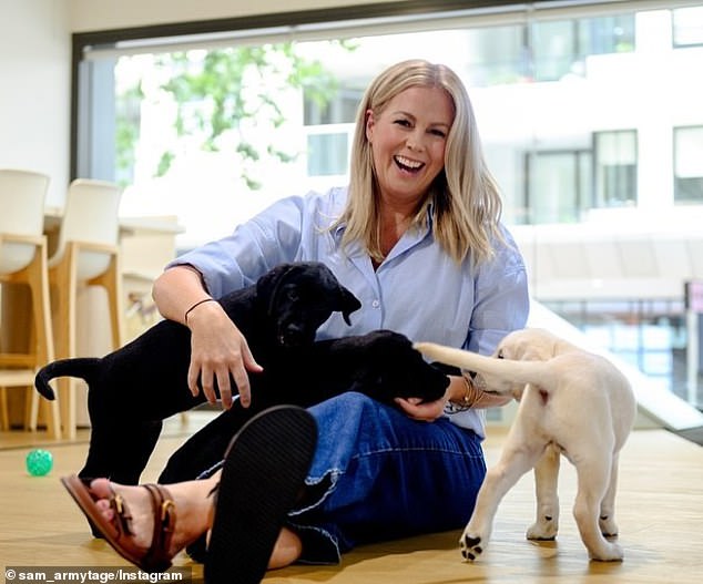 The 48-year-old cuddled up with an adorable Labrador as she revealed she has become an ambassador for Guide Dogs Australia