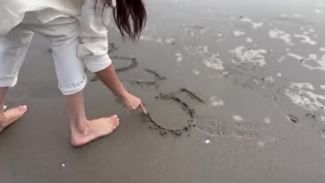 A video shows her playfully welcoming the New Year on the beach and writing 2025 in the sand