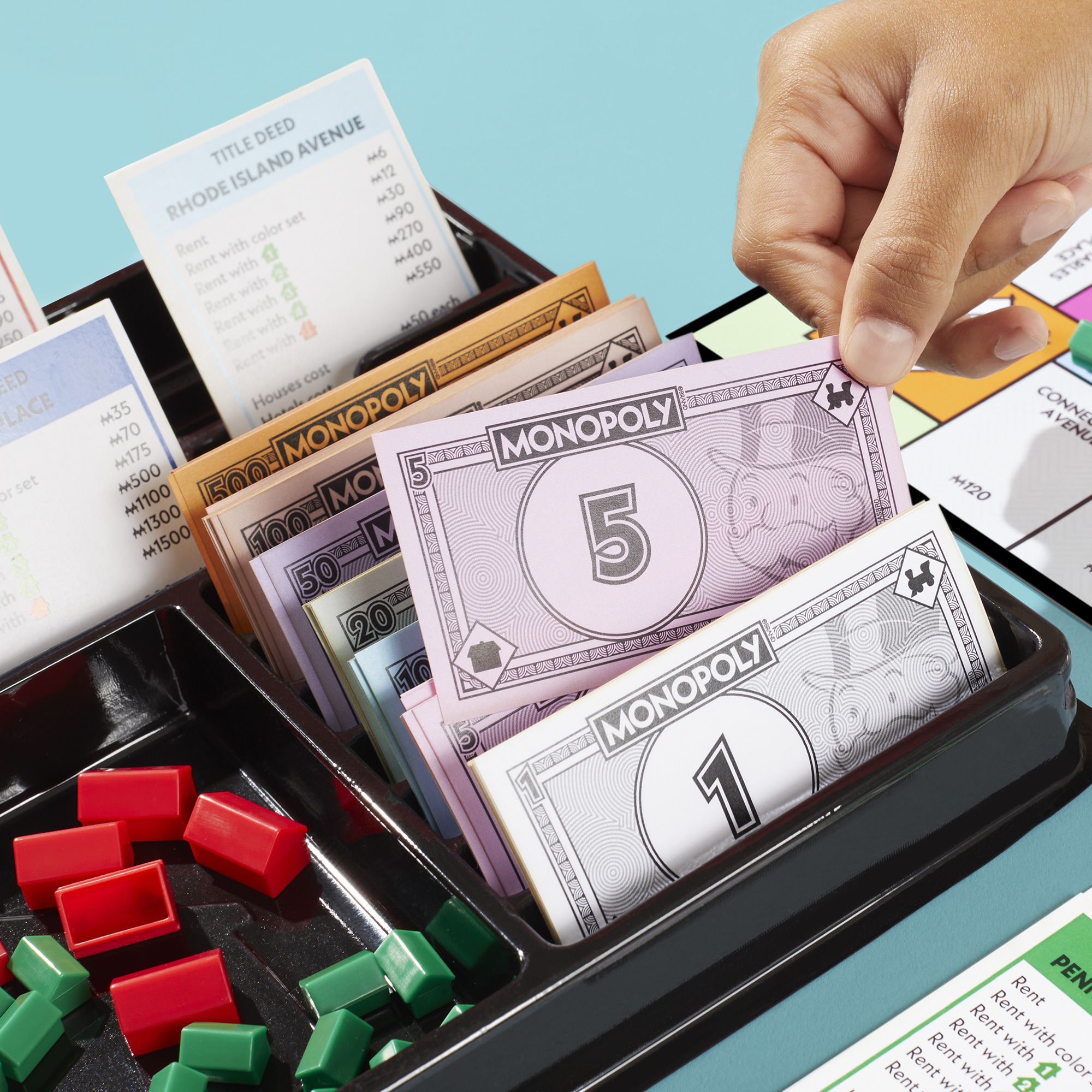 The new Monopoly storage tray keeps the money, title deeds and all houses and hotels within easy reach.