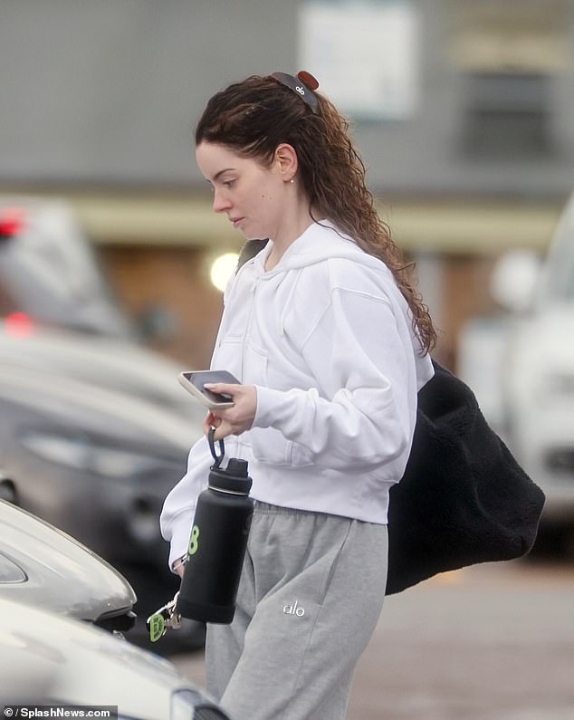 The reality star wore her hair in natural waves while carrying her gym bag and a black water bottle advertising Kendall Jenner's 818 Tequila!