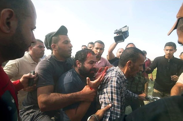 Yarden Bibas is pictured during his capture by Hamas on October 7 in a photo that appeared before his latest video. He is bleeding from a head wound and has blood on his hands. His relatives have not heard from him since