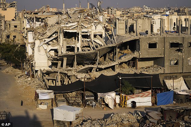 Palestinians walk through the destruction in Khan Younis, southern Gaza Strip, on January 7, 2025