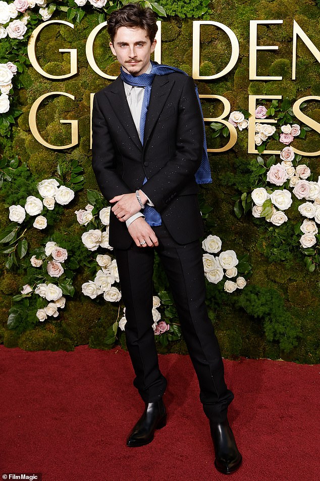 Timothee went solo on the carpet, wearing a scarf instead of a tie in tribute to the boho chic that became an indelible part of Bob Dylan's image