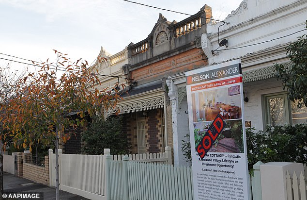 Australia's two largest cities are showing signs of a property downturn. There's a 'sold' sign outside a house in Brunswick, Melbourne