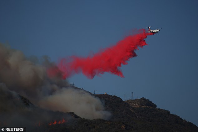 Fire retardant is dropped over the flames in Pacific Palisades