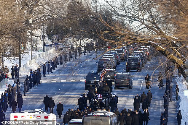 The U.S. Army caisson detachment with Carter's casket as people watch from the snow-lined streets of Washington, D.C., on January 7