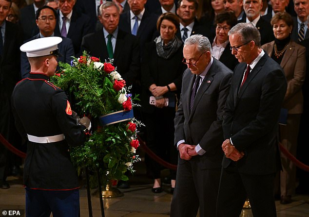 Senate Majority Leader John Thune and Minority Leader Chuck Schumer present a wreath during the ceremony for former President Carter