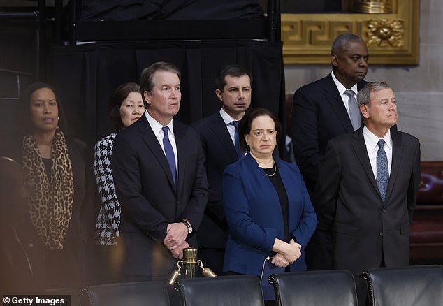 Supreme Court Chief Justice John Roberts, Justices Brett Kavanaugh and Elena Kagan, Secretary of Transportation Pete Buttigieg, Secretary of Defense Lloyd Austin and Washington, DC Mayor Muriel Browser during the ceremony for former President Carter at the U.S. Capitol