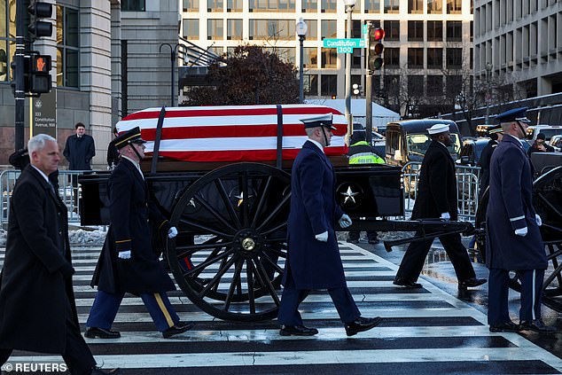 Former President Carter's casket was moved to a horse-drawn caisson at the US Navy Memorial before making its way to the US Capitol