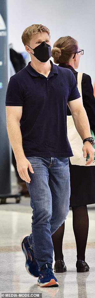 Robert, masked upon arrival, dressed casually in relaxed jeans and a navy blue polo shirt