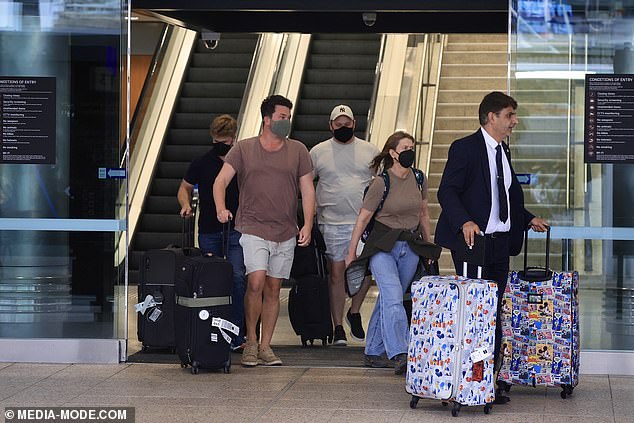 The mother-of-two's luggage was decorated with Disney characters such as Mickey Mouse, making it stand out from the travelers' plain-colored bags