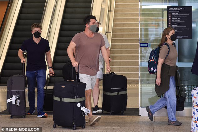 The group rolled several pieces of luggage through the terminal