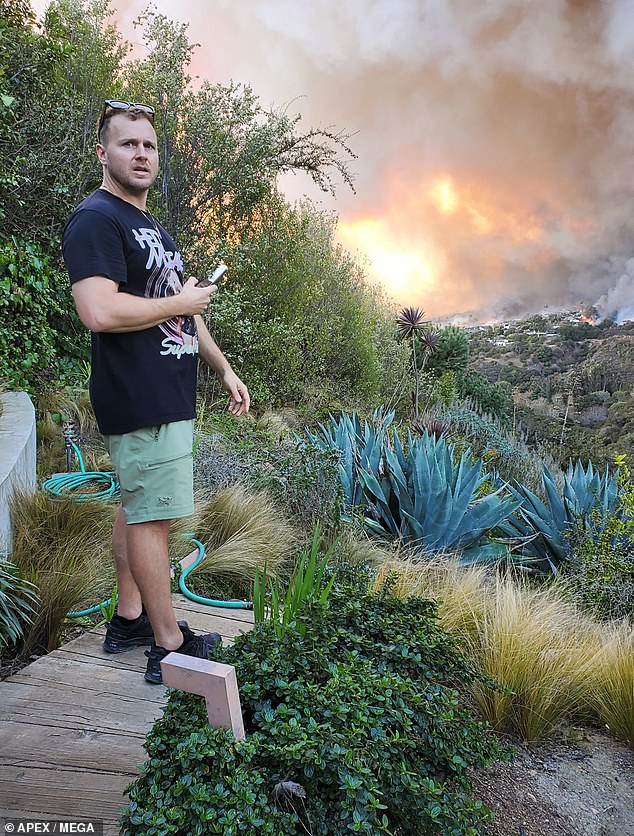 Pratt, 41, was captured in photos watching the fast-moving fire move toward his home, which is in an area with many celebrity estates also at risk of burning