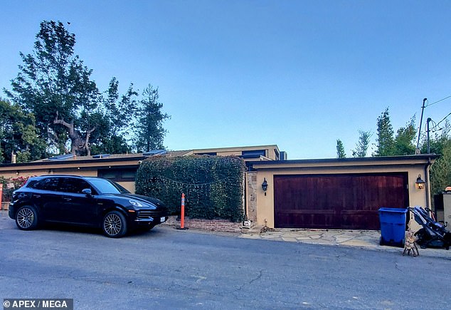 Spencer was seen in photos and video watching the rapidly advancing wildfire from near the home he and Heidi share with their two young sons; their house is pictured before the fire reached it