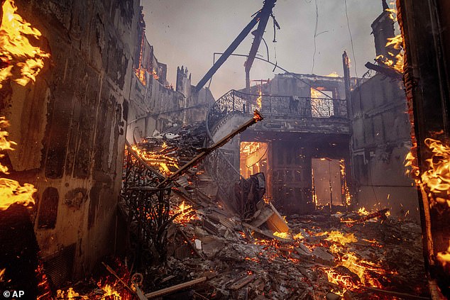 The intense wildfire rages through a home in Pacific Palisades