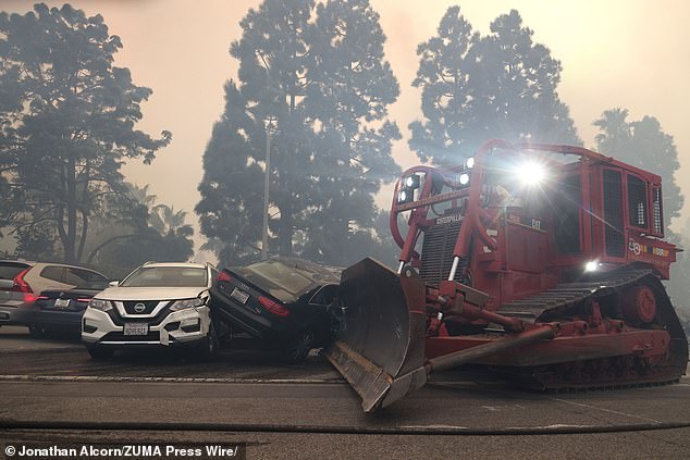 With panicked residents fleeing on foot, the city has deployed bulldozers to clear the streets of abandoned cars and clear a path for first responders to access the hills where the fire rages.