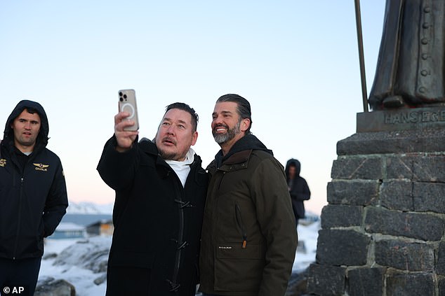 Donald Trump Jr., right, poses for a photo as he arrives in Nuuk, Greenland, Tuesday, January 7, 2025