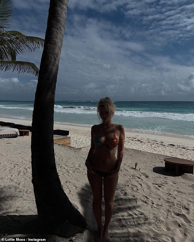 The beauty caused a storm by a palm tree on the beach as she flaunted her curves in this stunning two-piece set.