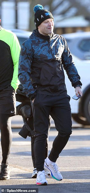 He kept warm in a Prostate Cancer UK charity hat with pom poms