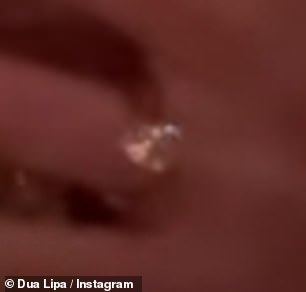 Dua Lipa wears the huge diamond sparkler on her engagement finger