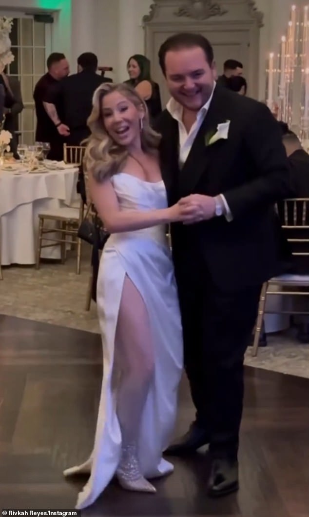 Caitlin stunned in a strapless satin dress with a daring thigh-high slit revealing a pair of dazzling white thigh-high boots as she danced with her dapper new husband