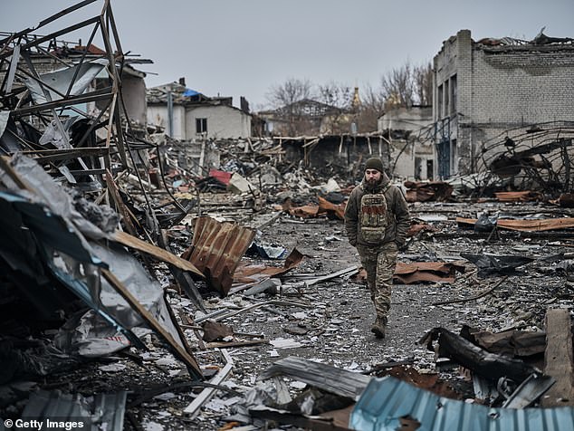 A soldier walks through a destroyed central market near the front line in Ukraine