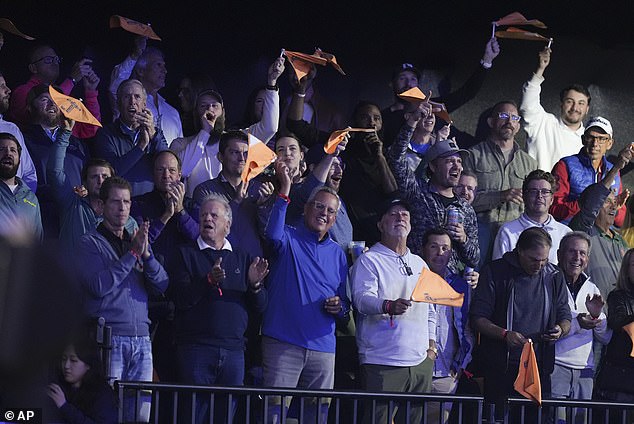 The fans in the arena enjoyed the fun, waving their flags and even taking a few shots