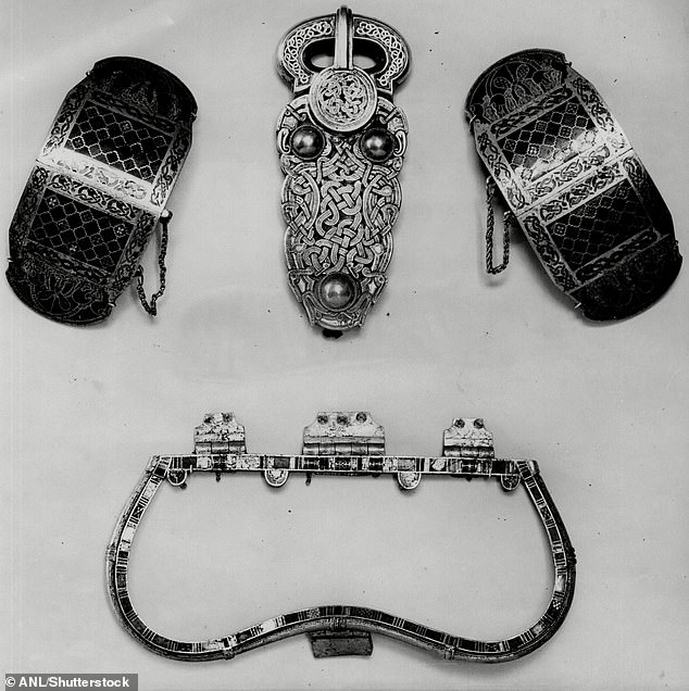 Pictured: A pair of hinged gold clasps, decorated with garnet and mosaic glass, each with a chained mounting pin in the shape of an animal head, found at Sutton Hoo