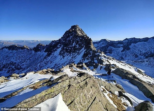 Rescuers have released photos of their search for two missing hikers in the Dolomites