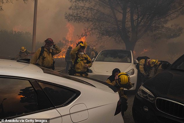 Torrance firefighters are seen preparing to battle the Palisades fire. Fighting the fires is difficult due to the strong winds