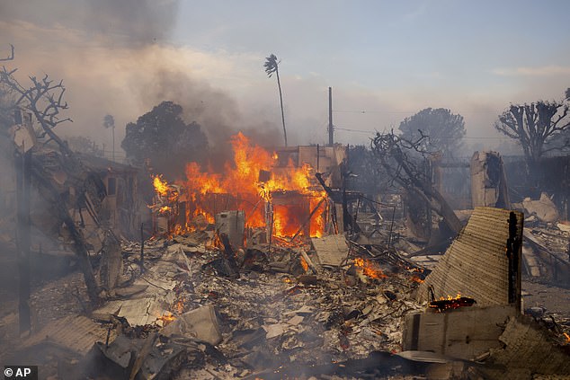 The Palisades Fire burns a building in the Pacific Palisades neighborhood of Los Angeles