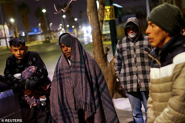 Migrants trying to reach the United States pray outside a shelter during a day of low temperatures, in Ciudad Juarez, Mexico, January 7