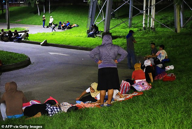 Hondurans rest before embarking on a migration caravan to the US in San Pedro Sula, Honduras, on January 6, 2025. Dozens of Hondurans left the northwestern city of San Pedro Sula for the US in a caravan on January 7.