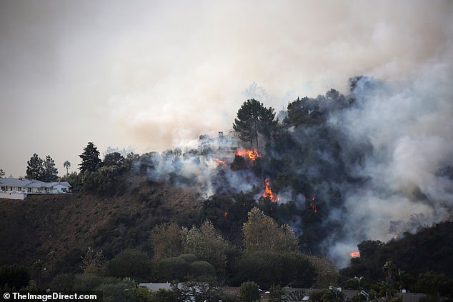 Flames can be seen tearing through the hillside at another home that appears to be near Fergie