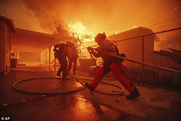 Firefighters protect a building as the Eaton fire progresses